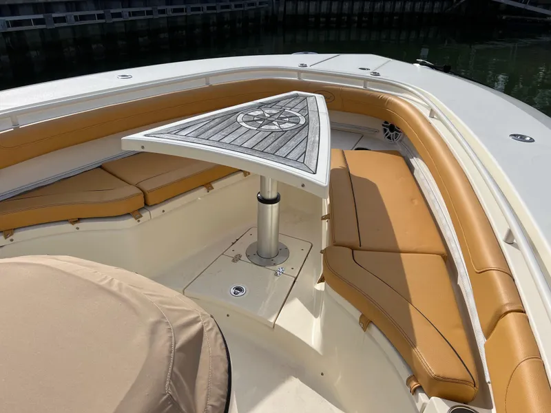 Slide: The Image of 2016 Scout 350 LXF boat interior with tan seating and a triangular table. - 39