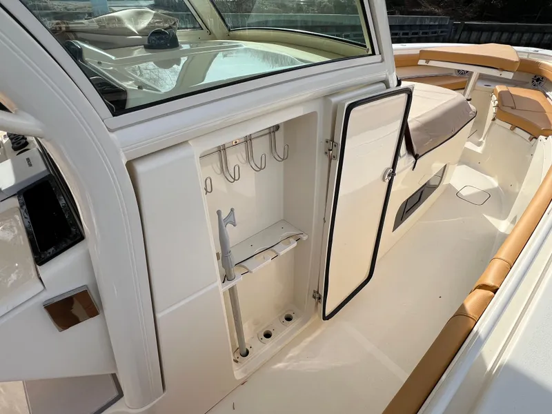 Slide: The Image of 2016 Scout 350 LXF boat interior with open storage compartment and seating area. - 40