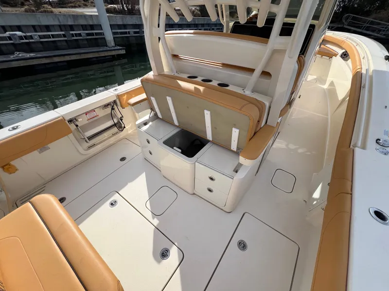 Slide: The Image of 2016 Scout 350 LXF boat interior with tan seating and storage compartments. - 43