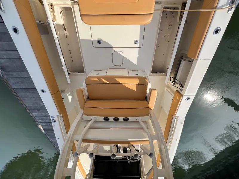 Slide: The Image of 2016 Scout 350 LXF boat interior with tan seating and sleek design. - 44