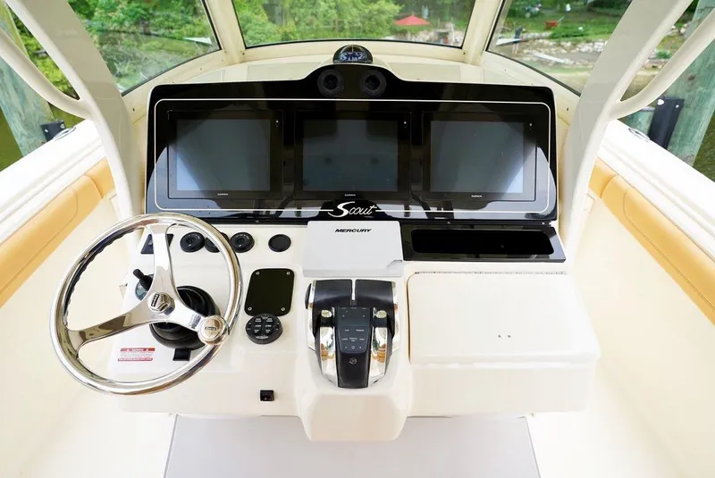 Slide: The Image of 2016 Scout 350 LXF boat dashboard with steering wheel and digital displays. - 5