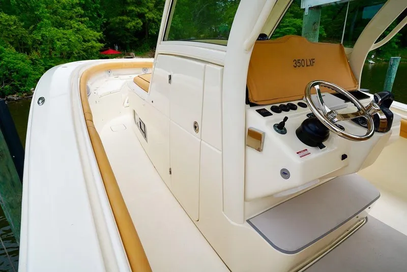 Slide: The Image of 2016 Scout 350 LXF boat interior with steering wheel and control panel. - 7