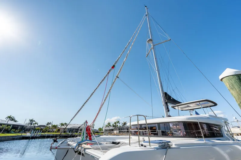 Slide: The Image of 2019 Lagoon 42 catamaran docked under clear blue sky. - 11