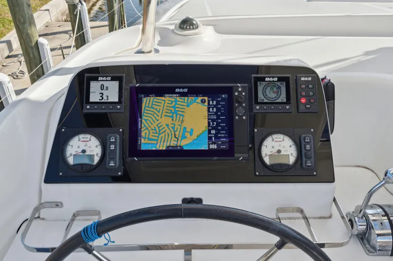 Slide: The Image of Control panel of 2019 Lagoon 42 catamaran with navigation instruments and steering wheel. - 17