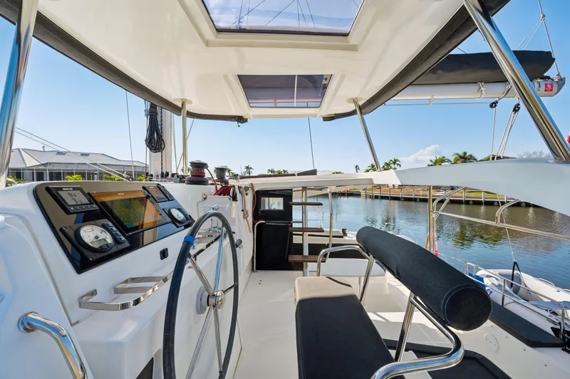 Slide: The Image of Cockpit view of 2019 Lagoon 42 catamaran with steering wheel and navigation instruments. - 20