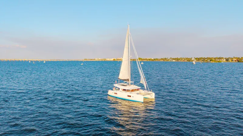 Slide: The Image of Sailing Lagoon 42 catamaran on open sea, 2019 model, under clear blue sky. - 3