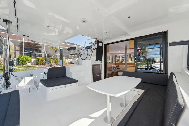 Slide: The Image of 2019 Lagoon 42 yacht interior with seating, table, and bicycle storage. - 44