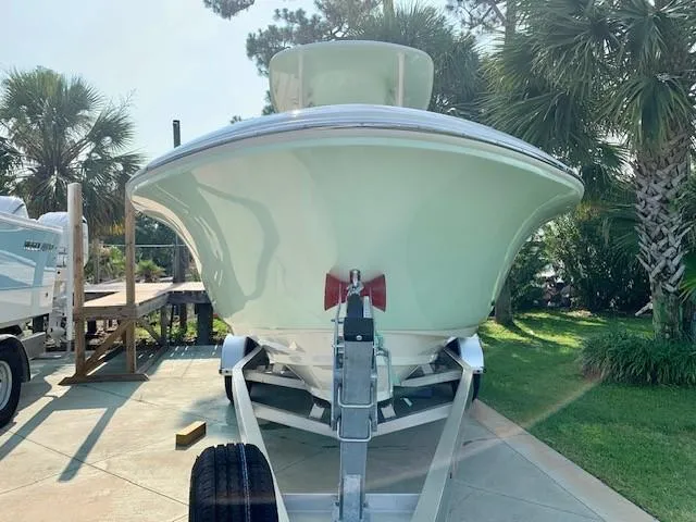 Slide: The Image of 2025 Pioneer 222 Islander boat on trailer, surrounded by palm trees. - 5