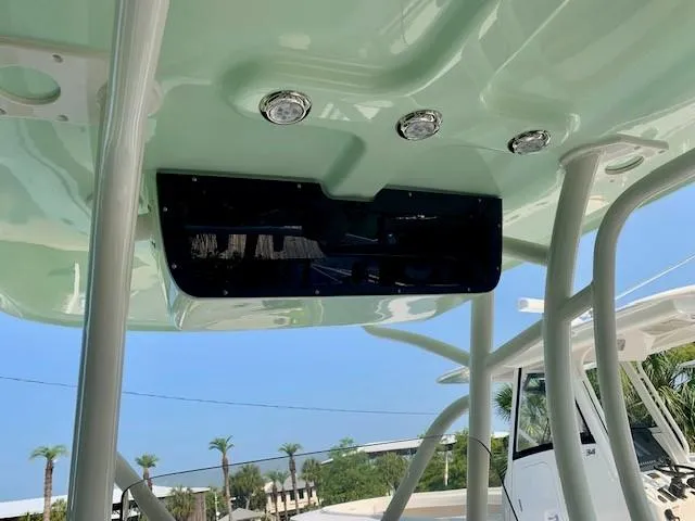 Slide: The Image of 2025 Pioneer 222 Islander boat canopy with integrated lights and sleek design. - 8