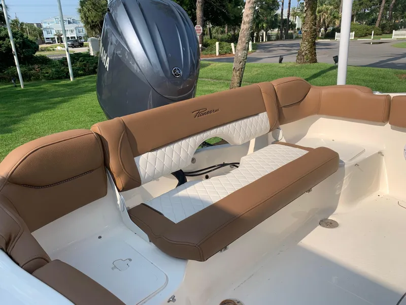 Slide: The Image of 2025 Pioneer 202 Islander boat interior with tan and white seating, Yamaha engine visible. - 11