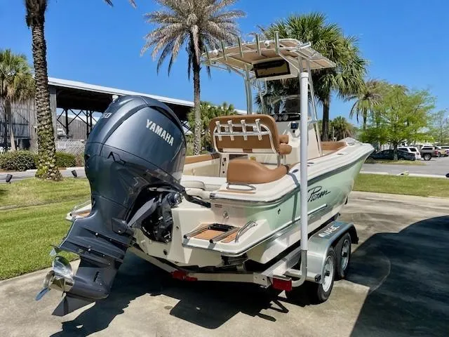 Slide: The Image of 2025 Pioneer 202 Islander boat with Yamaha engine on trailer, surrounded by palm trees. - 3