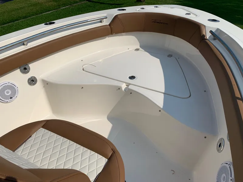 Slide: The Image of 2025 Pioneer 202 Islander boat interior with tan seating and stainless steel accents. - 4