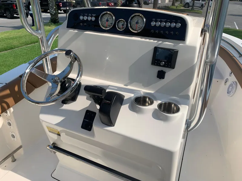 Slide: The Image of 2025 Pioneer 202 Islander boat dashboard with steering wheel, gauges, and controls. - 5