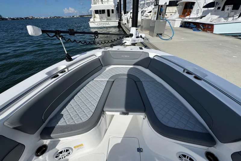 Slide: The Image of 2025 NauticStar 252 Legacy boat interior with cushioned seating and water view. - 21