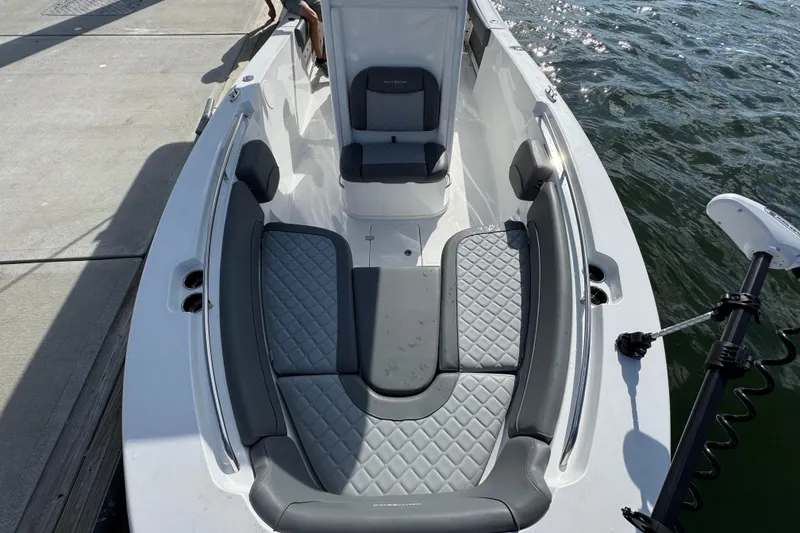Slide: The Image of 2025 NauticStar 252 Legacy boat interior with cushioned seating and sleek design. - 24
