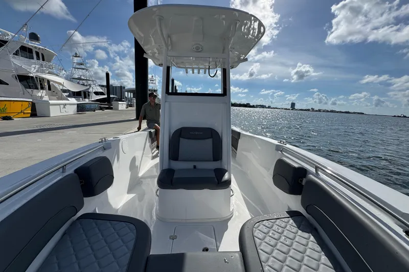 Slide: The Image of 2025 NauticStar 252 Legacy boat docked, featuring spacious seating and modern design. - 26