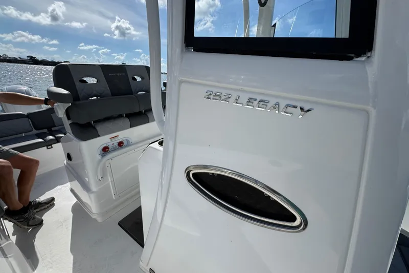 Slide: The Image of 2025 NauticStar 252 Legacy boat interior with seating and branding details. - 28