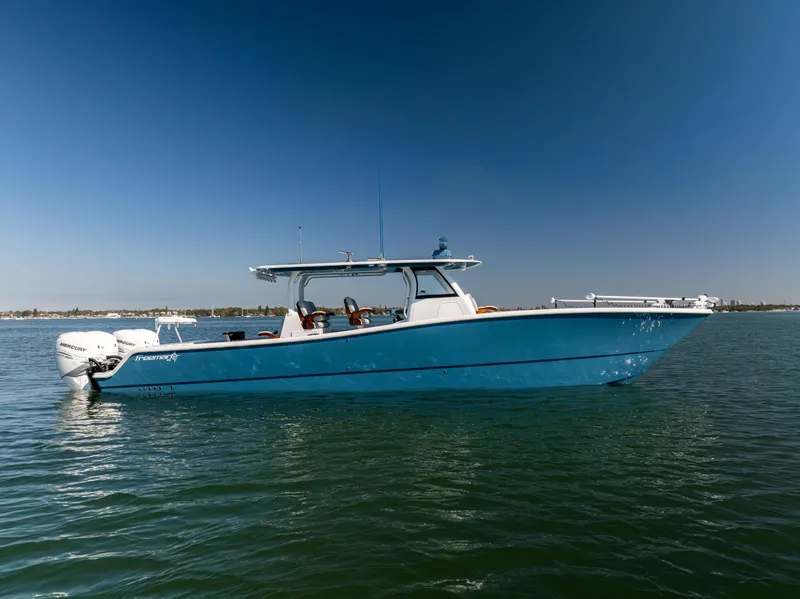 Slide: The Image of 2022 Freeman 43 boat on calm water under clear blue sky. - 0