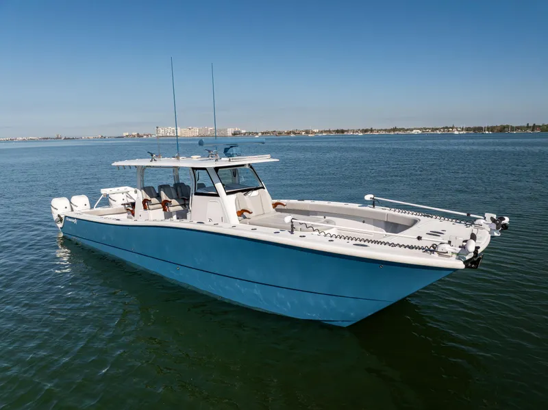 Slide: The Image of 2022 Freeman 43 boat on calm water, featuring a sleek blue design. - 1