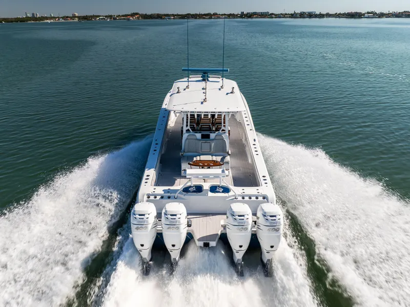 Slide: The Image of Freeman 43 boat, 2022 model, cruising on open water with four powerful engines. - 11