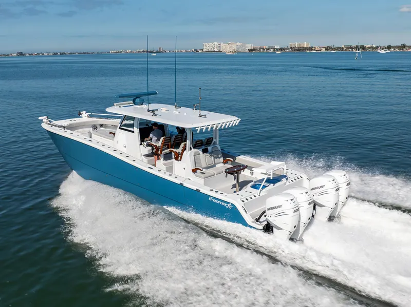 Slide: The Image of Freeman 43 boat cruising on water, 2022 model, with powerful outboard engines. - 15