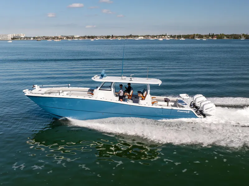 Slide: The Image of 2022 Freeman 43 boat cruising on open water, featuring a sleek blue design. - 16