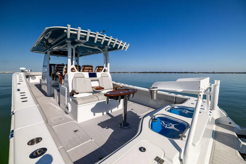 Slide: The Image of 2022 Freeman 43 boat with spacious deck and seating, under clear blue sky. - 20