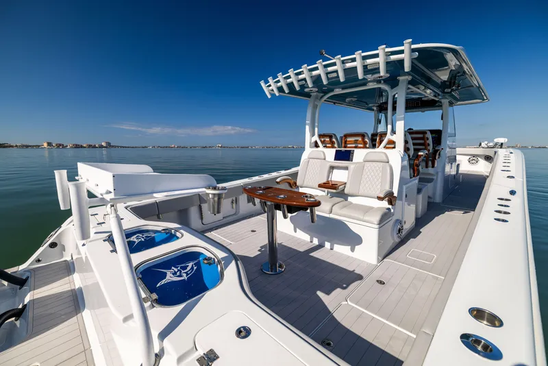 Slide: The Image of 2022 Freeman 43 boat with spacious deck and seating on calm water. - 21