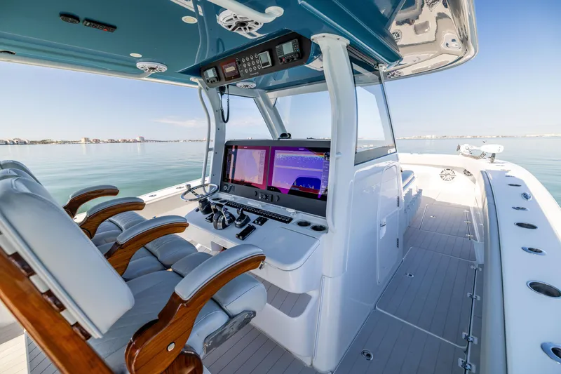 Slide: The Image of Modern Freeman 43 boat cockpit with advanced navigation system, 2022 model, on calm waters. - 39