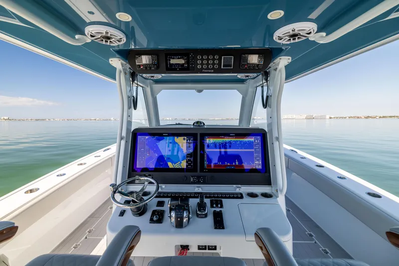 Slide: The Image of 2022 Freeman 43 boat cockpit with advanced navigation systems on calm water. - 42