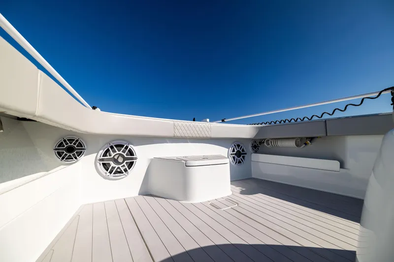 Slide: The Image of Freeman 43 boat deck, 2022 model, featuring sleek design and modern speakers under clear blue sky. - 48