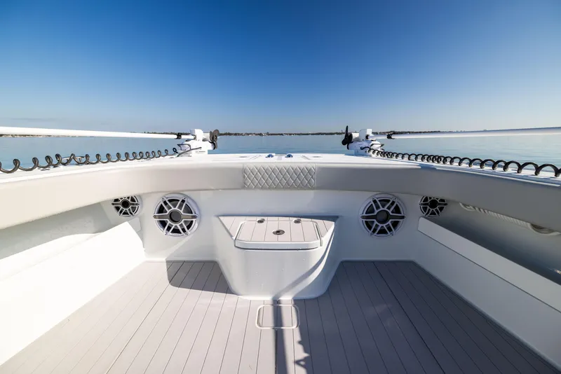 Slide: The Image of Freeman 43 boat deck, 2022 model, with speakers and ocean view under clear blue sky. - 49
