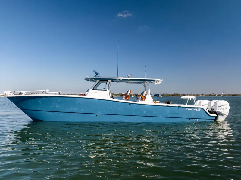 Slide: The Image of 2022 Freeman 43 boat in blue, cruising on calm waters under a clear sky. - 5