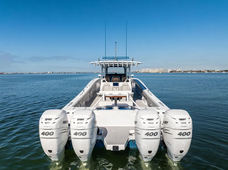 Slide: The Image of 2022 Freeman 43 boat with four Mercury 400 engines on calm water. - 8