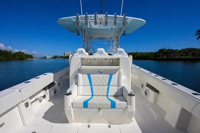 Slide: The Image of 2008 SeaVee 39b boat with white and blue seating, on a calm waterway. - 11