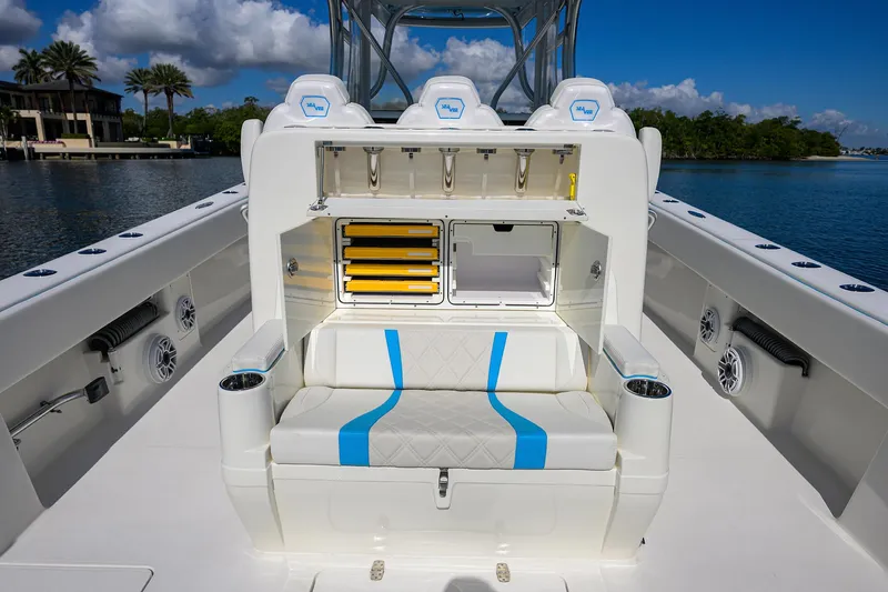 Slide: The Image of 2008 SeaVee 39b boat interior with seating, storage, and rod holders on a sunny day. - 12