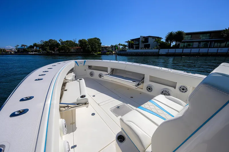 Slide: The Image of 2008 SeaVee 39b boat interior with seating, on a sunny waterfront. - 2
