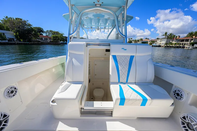 Slide: The Image of 2008 SeaVee 39b boat interior with seating and cabin, docked by waterfront homes. - 26