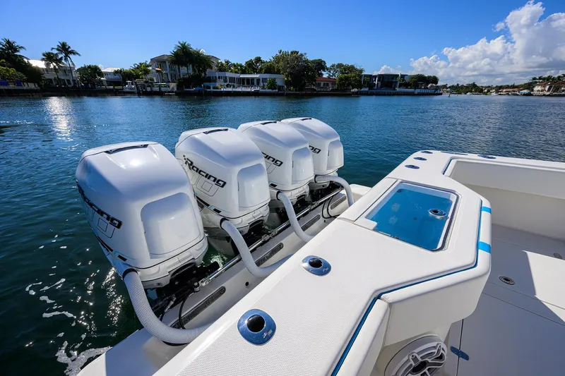 Slide: The Image of 2008 SeaVee 39b boat with four powerful outboard engines on a sunny waterfront. - 31
