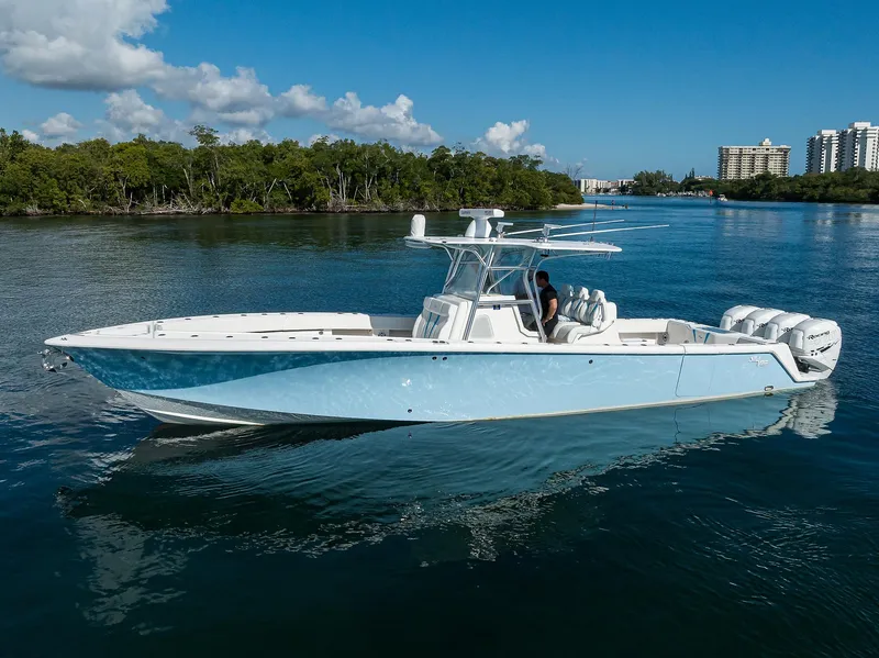 Slide: The Image of 2008 SeaVee 39b boat on calm water, clear sky, and distant buildings. - 33