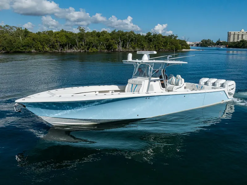Slide: The Image of 2008 SeaVee 39b boat cruising on a calm waterway under a clear blue sky. - 5