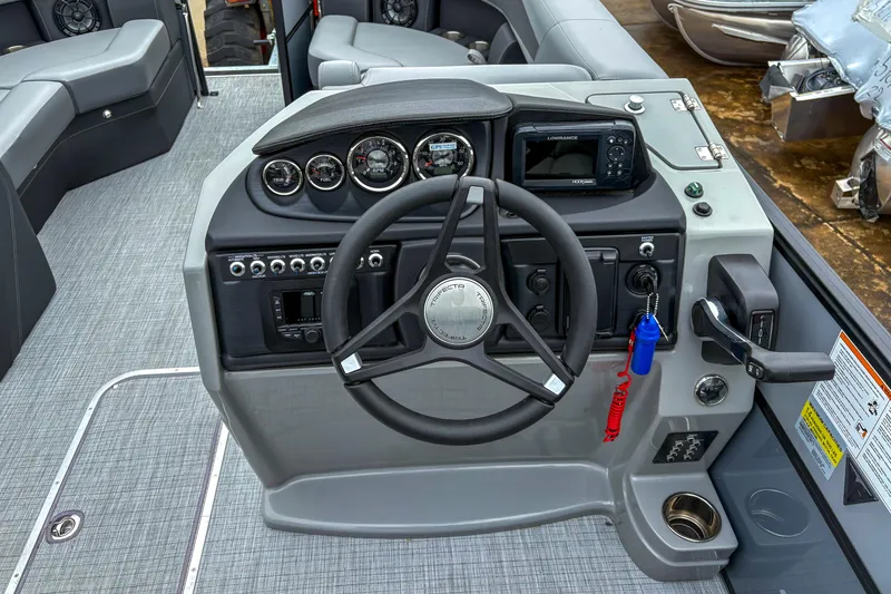 Slide: The Image of 2025 Trifecta 24 RF CS boat dashboard with steering wheel and control panel. - 8