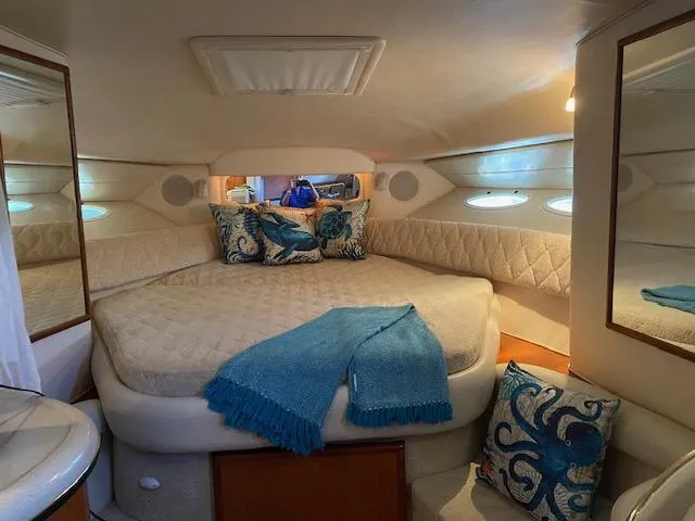 Slide: The Image of Luxurious 2002 Sea Ray Sundancer cabin with cozy bed and nautical decor. - 10