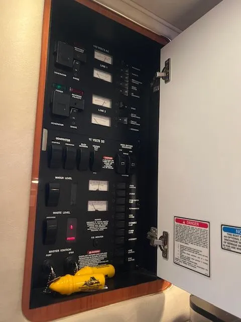 Slide: The Image of Control panel inside a 2002 Sea Ray Sundancer boat, featuring various switches and indicators. - 24