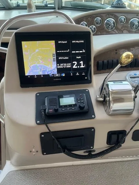 Slide: The Image of Control panel of a 2002 Sea Ray Sundancer boat with GPS and radio equipment. - 25