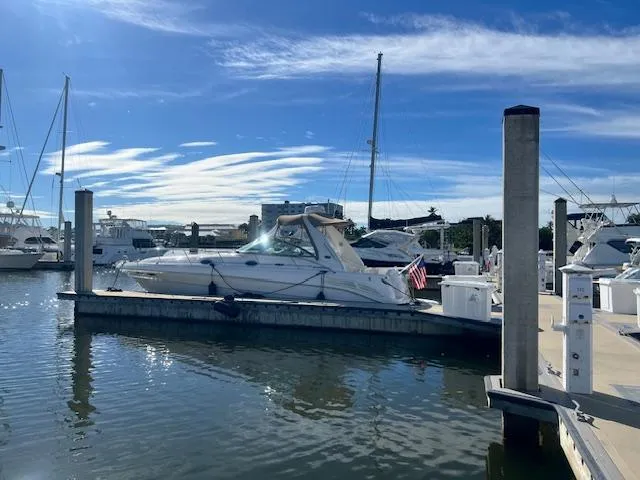 Slide: The Image of 2002 Sea Ray Sundancer yacht docked at marina under clear blue sky. - 3