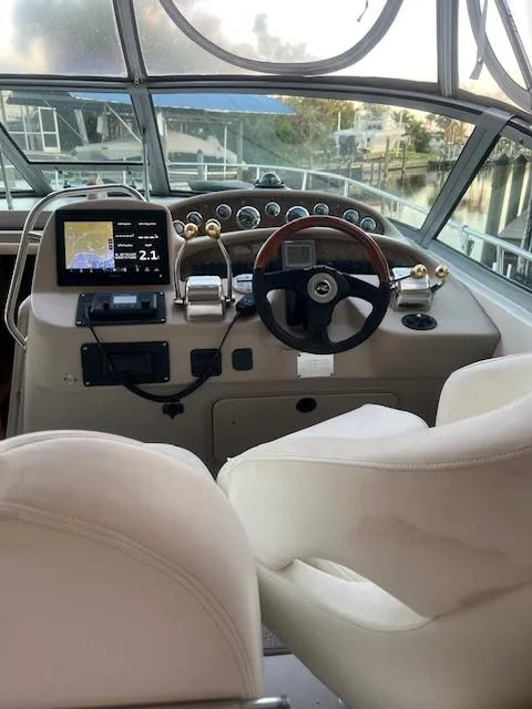 Slide: The Image of 2002 Sea Ray Sundancer helm with modern navigation equipment and luxurious seating. - 7