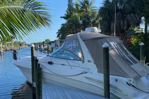 Slide: The Image of 2002 Sea Ray Sundancer docked by a tropical canal with lush palm trees. - 8