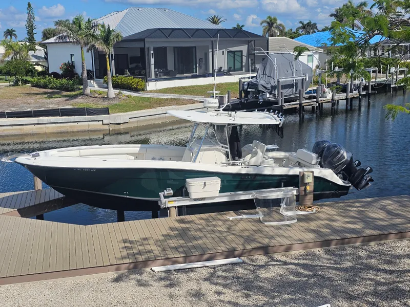 Slide: The Image of 2006 Hydra-Sports Vector 3300 CC boat docked by waterfront home. - 0