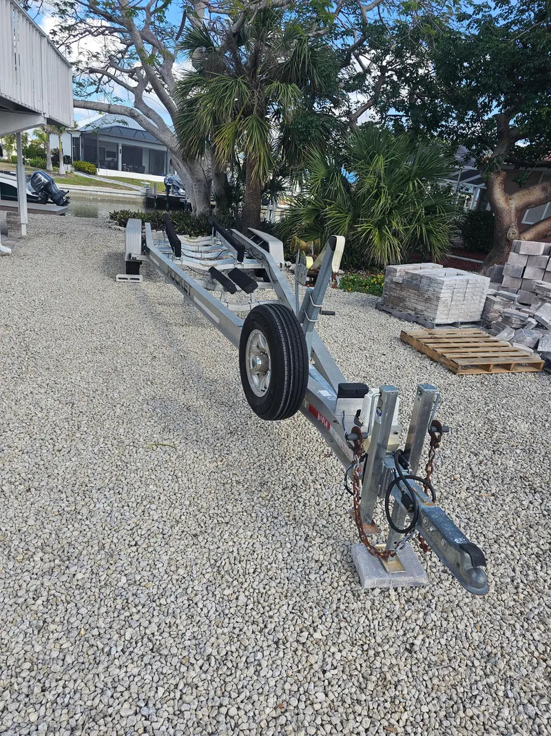 Slide: The Image of Boat trailer on gravel, surrounded by trees and buildings, for 2006 Hydra-Sports Vector 3300 CC. - 13